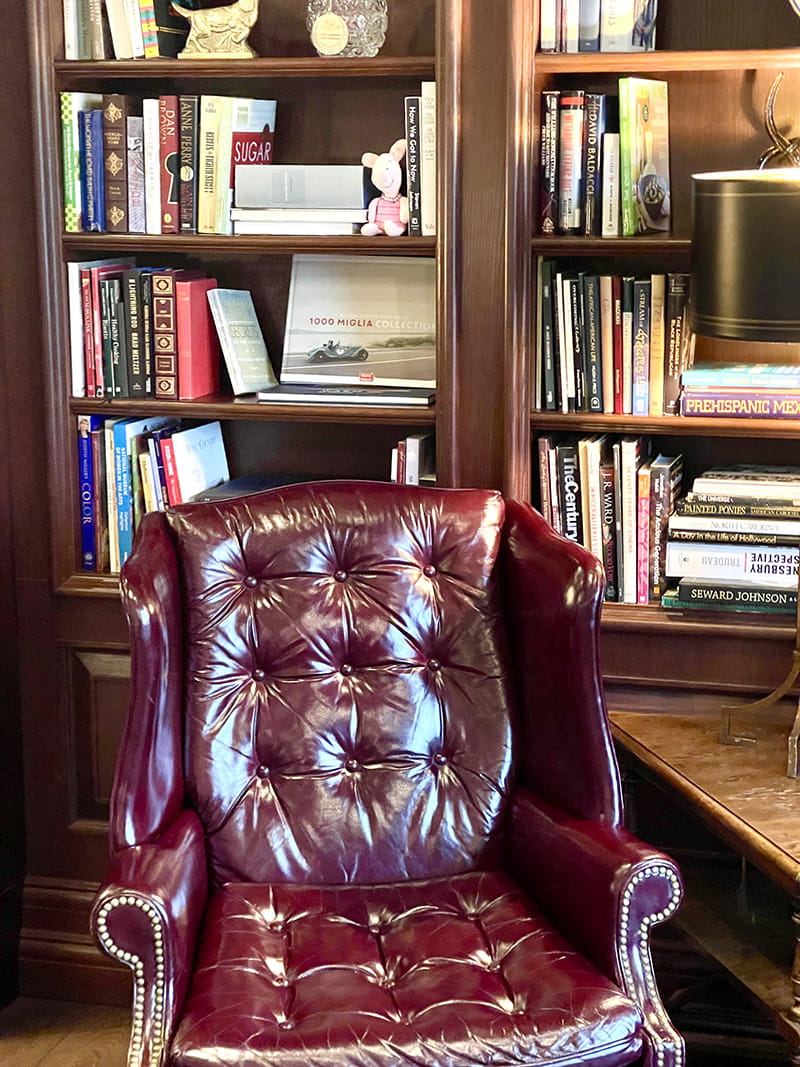Leather chair in front of a bookshelf