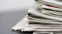 Stack of folded newspapers