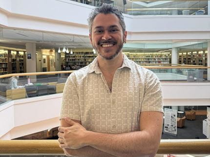 Jeam Da Silva Camilo smiles in a headshot in W. W. Hagerty Library. 