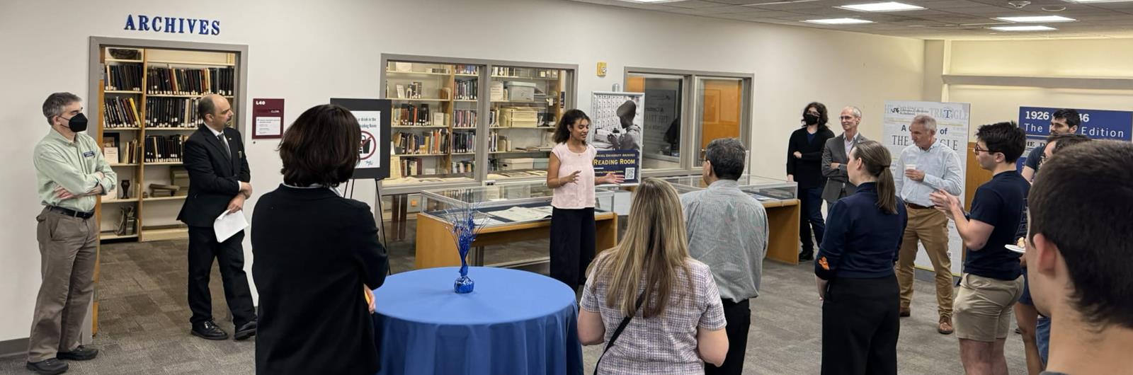 A crowd of people watch as a women gives a speech