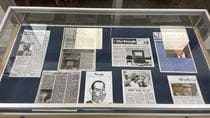 A display case with copies of The Triangle student newspaper