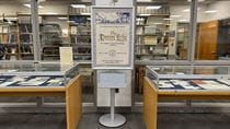 A photo of the cases and signage displaying the exhibit "The Drexel Echo: The Origins of Student Publishing at Drexel".