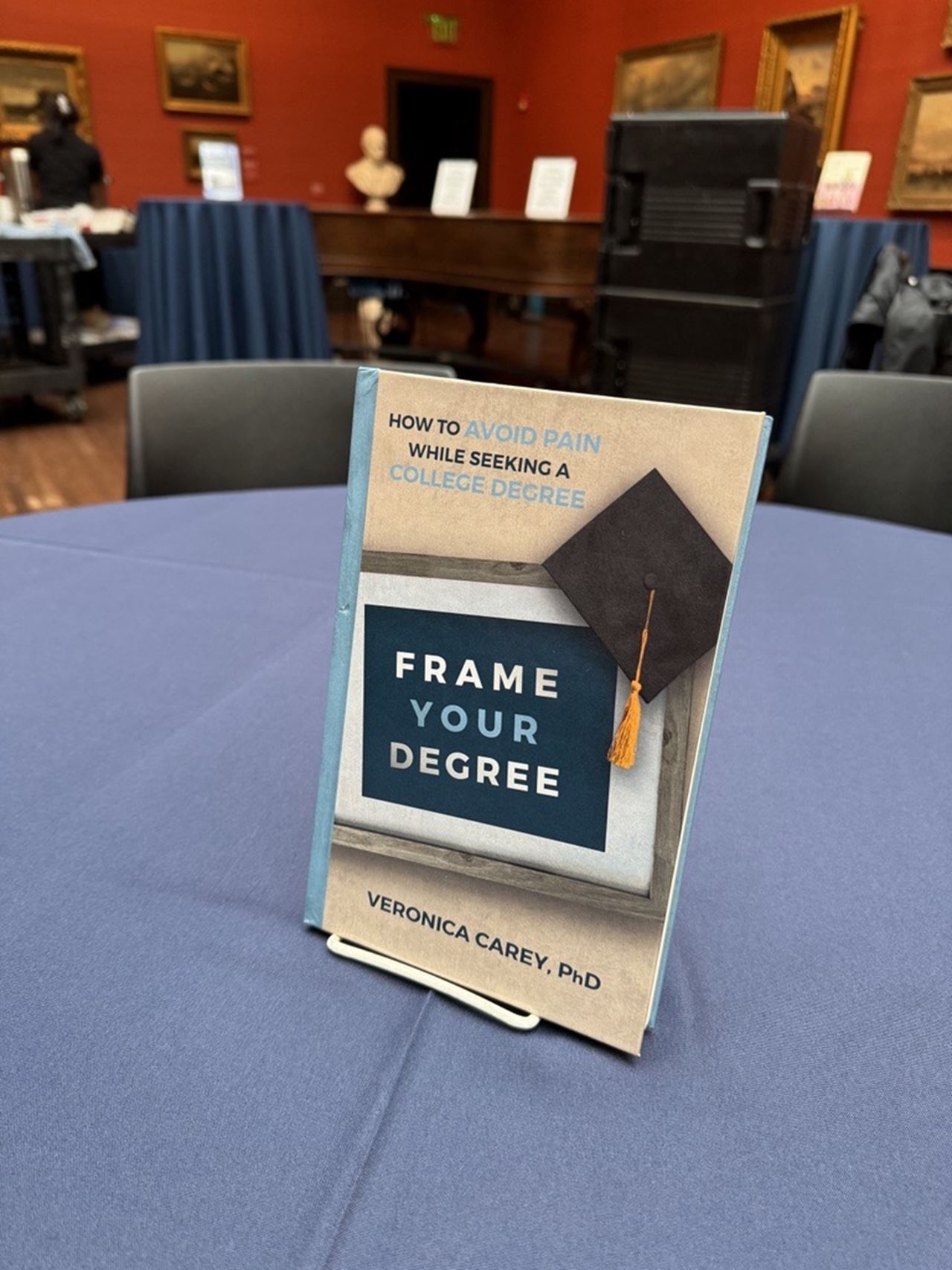 The book Frame Your Degree by Vernoica Carey on a table in the AJ Drexel Picture Gallery 