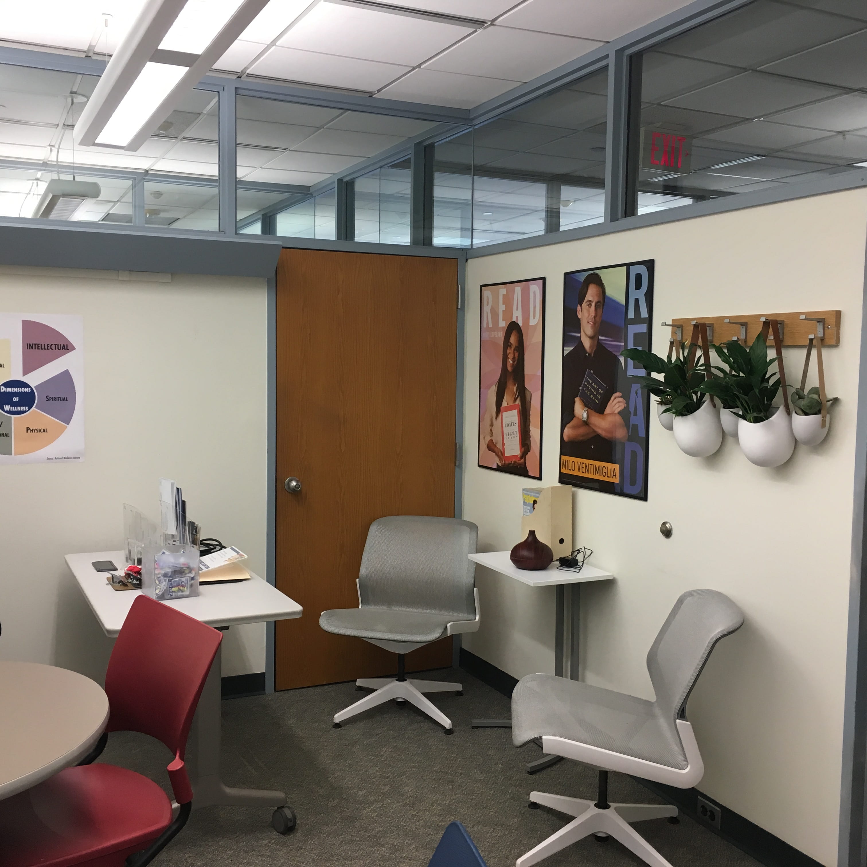 A room with two chairs and a small table with an aromatherapy macine on the table.