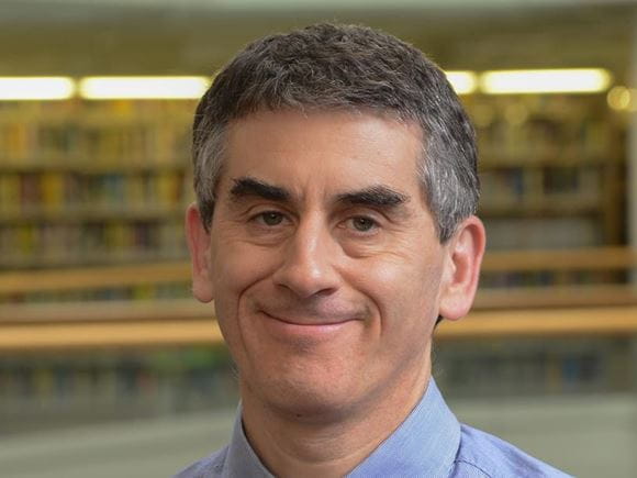 headshot of a man in the library